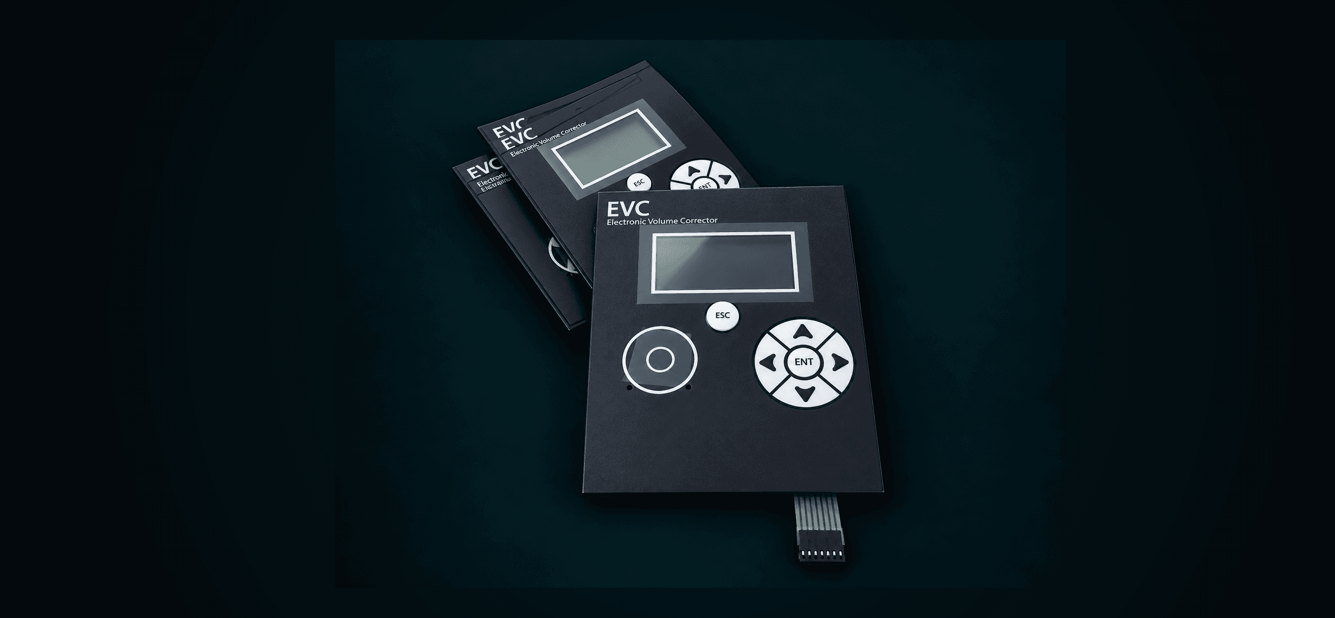 A stack of EVC graphic overlay keypads, showing the display window, the five-way arrow and ENT navigation cluster, the ESC button, the round action button, and the flex-cable tail