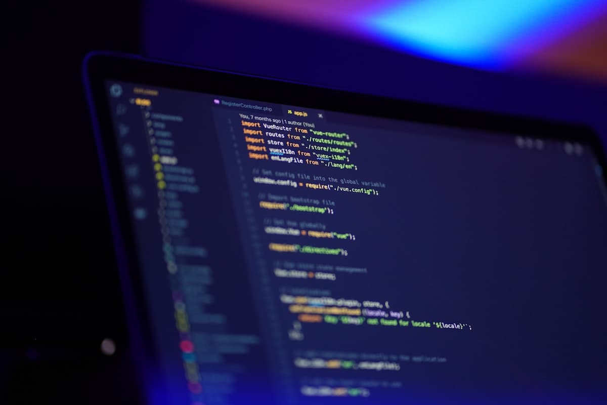 A laptop screen displaying colorful, syntax-highlighted code