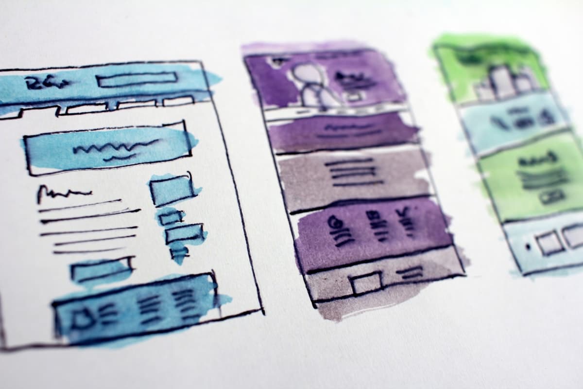 Hand-drawn watercolor wireframe sketches of website and app layouts