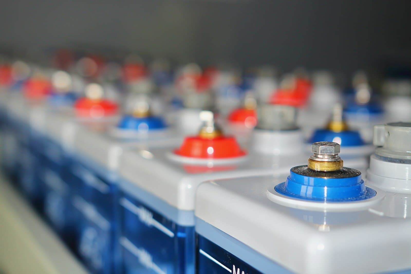 Close-up of a row of battery cells with colored terminals