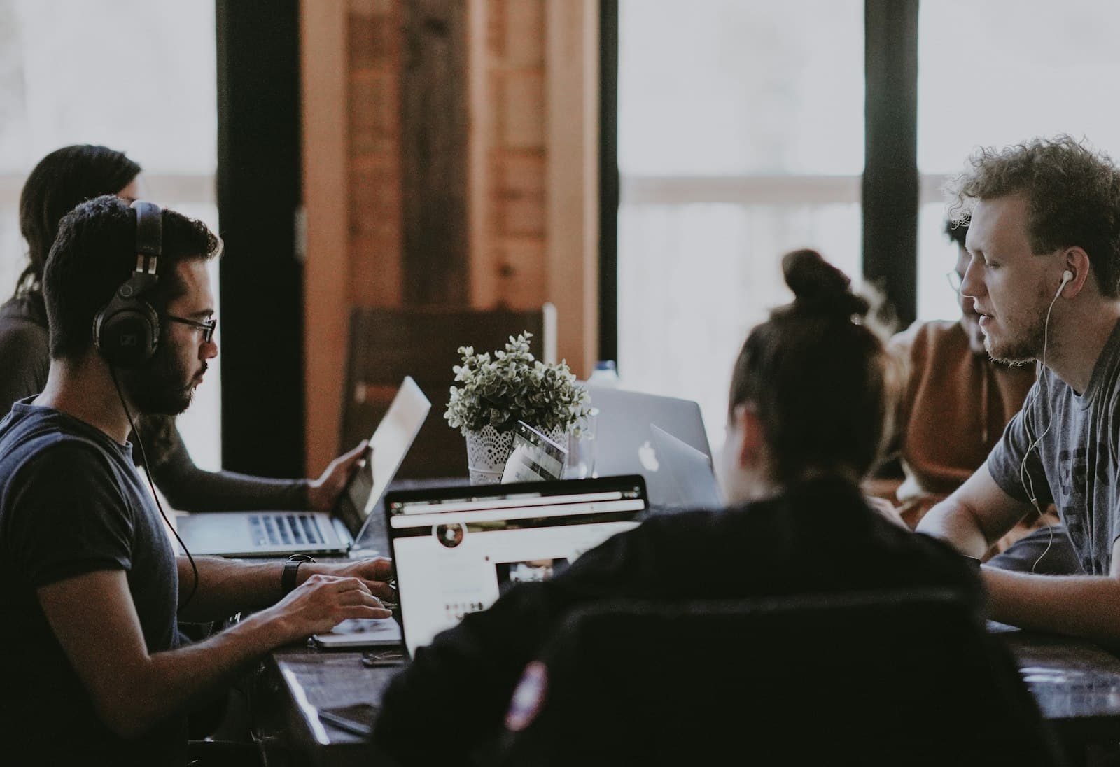 A team of engineers reviewing information together on a laptop