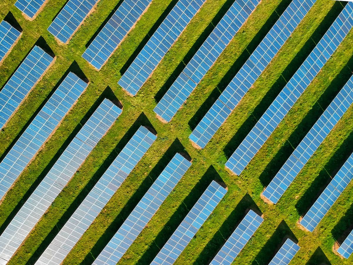 Aerial view of rows of solar panels on a solar farm